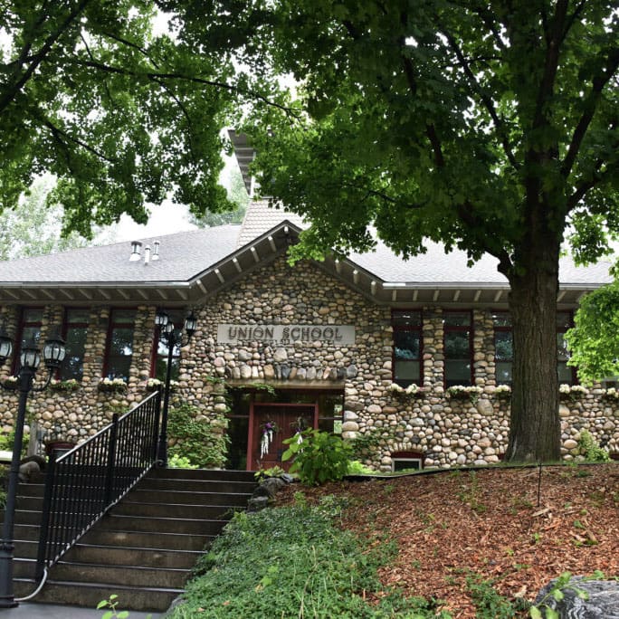 A stone building with stairs leading to it.