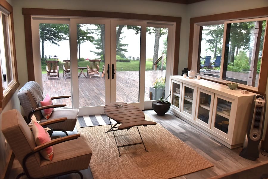 A living room with sliding glass doors and a large deck.